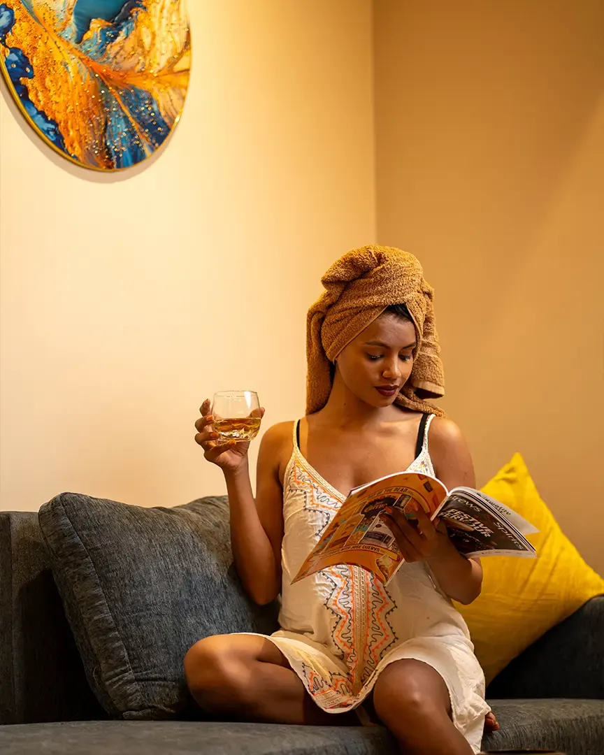 Guest reading in a lounge with colourful cushions