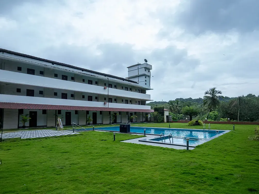 Building and lawn with a pool at Holiday Village