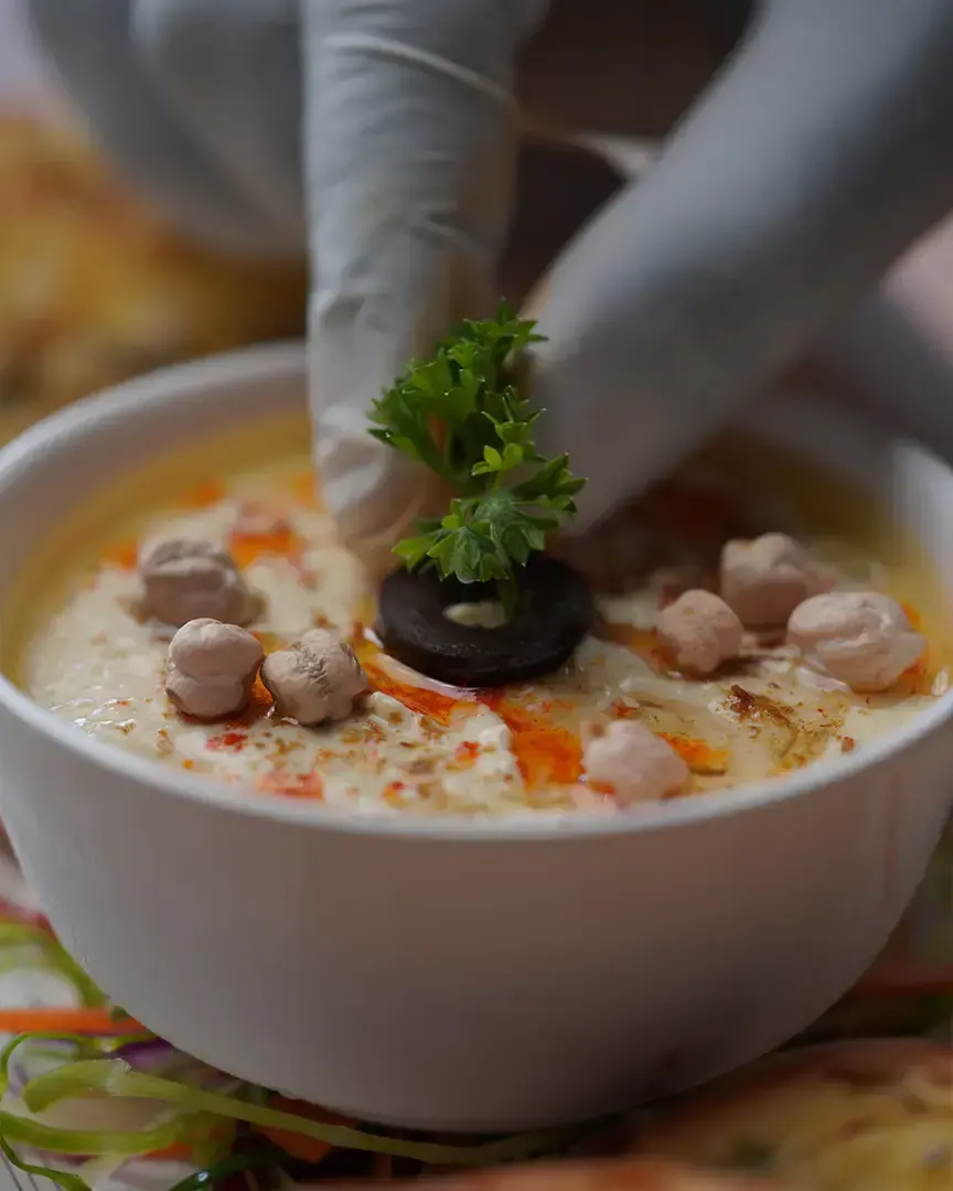 Garnishing a bowl of soup